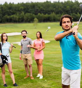 Friends playing golf in a field