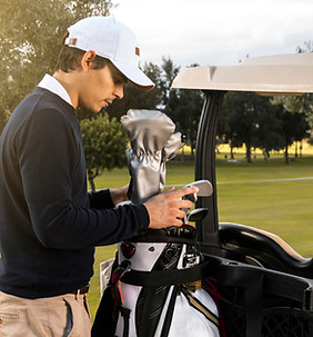Man putting clubs in a golf cart